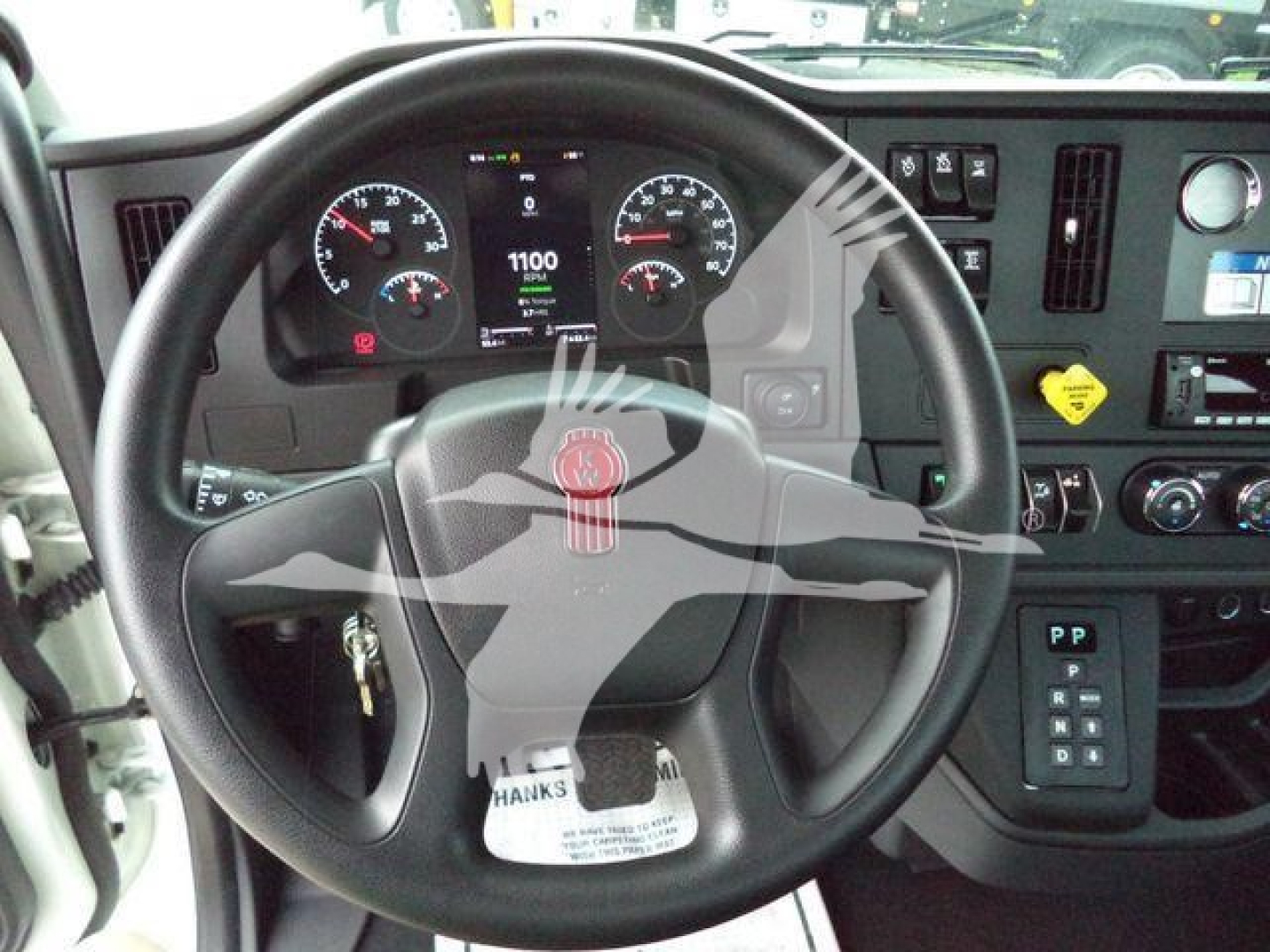 Kenworth T280 dashboard and steering wheel interior showing gauges and digital display.