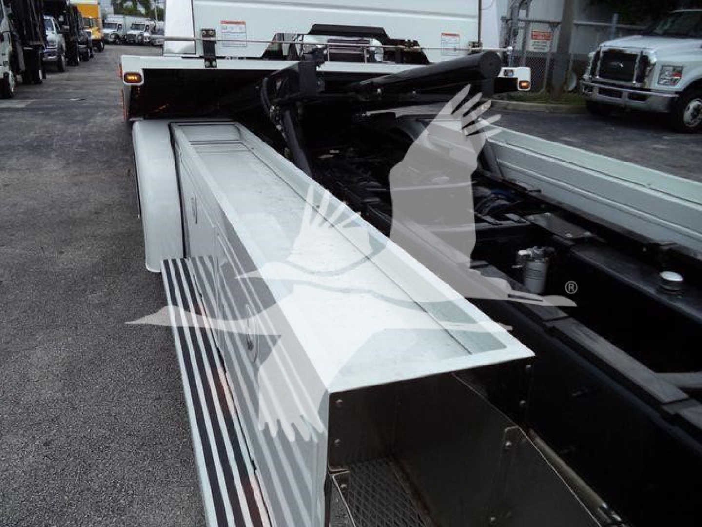 Kenworth T280 rollback truck chassis with extended side steps and hydraulic line visible.