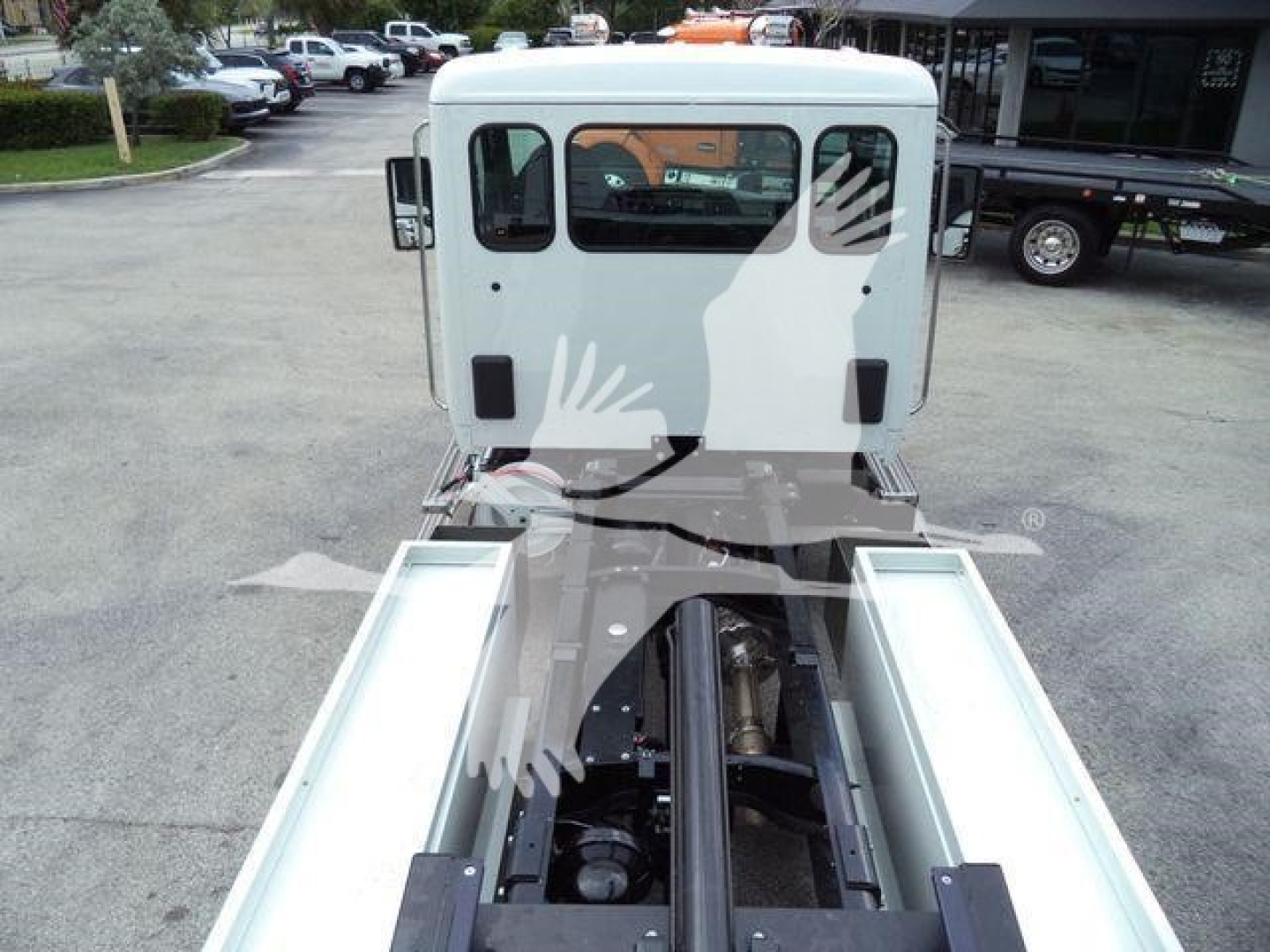 Kenworth truck cab viewed from rear with rollback rails and chassis showing undercarriage and frame.