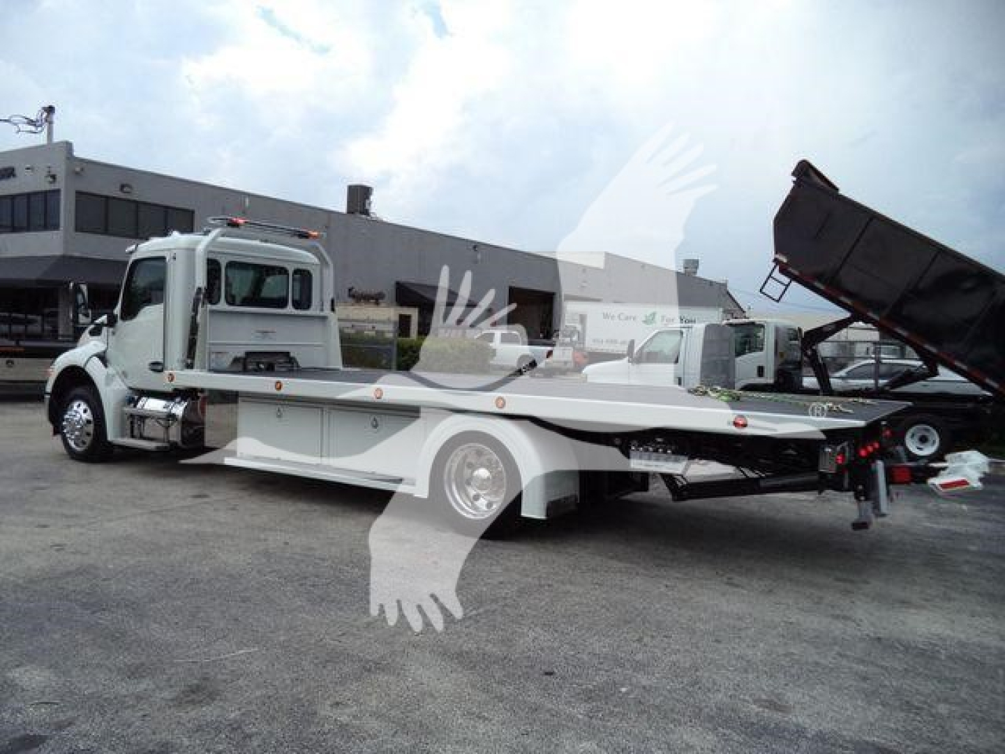 Kenworth T280 rollback tow truck with flatbed extended, white color, side view showing cab and long bed.