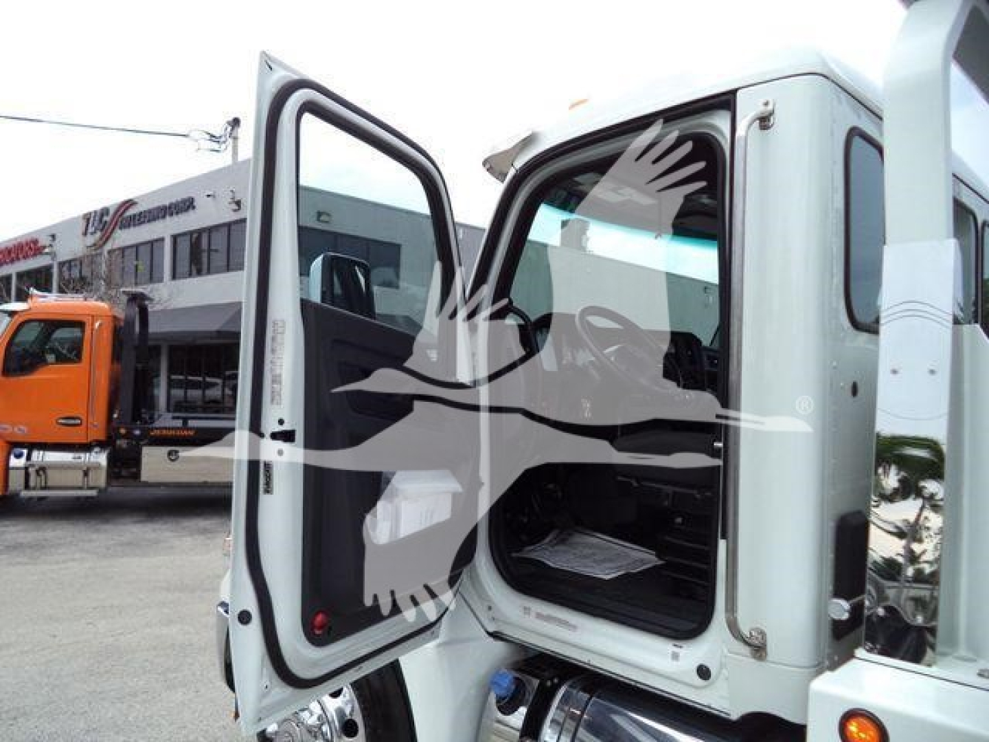 Kenworth T280 rollback truck cab with rear doors open; visible text includes stock number KW1STEPSIDEWHT on listing context; image shows truck decals and equipment bay.