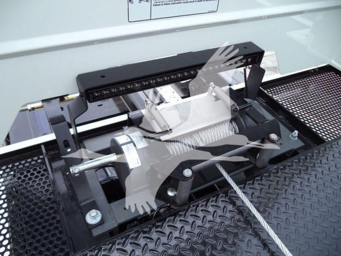 Kenworth T280 rollback truck equipment showing winch and mounting hardware with visible steel cable and mounting bar.
