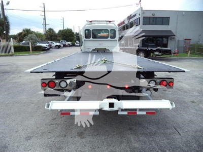 Kenworth T280 rollback truck rear view showing flatbed deck and rear lights.