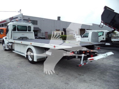 Kenworth T280 rollback truck rear quarter view showing flatbed and rear ramps.