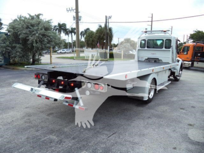 Kenworth rollback truck with flatbed and rear ramps; white color; side and rear view showing hitch and hydraulic equipment