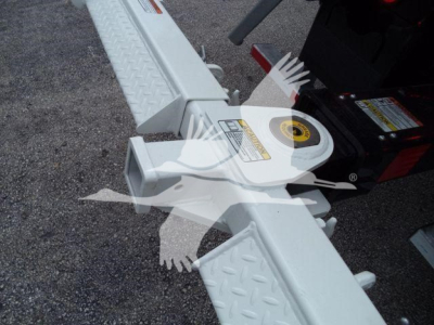 Kenworth T280 rollback stock image showing white aluminum wheel lift mechanism with diamond plate steps and warning labels.