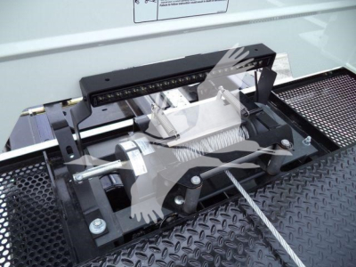 Kenworth T280 rollback truck equipment showing winch and mounting hardware with visible steel cable and mounting bar.