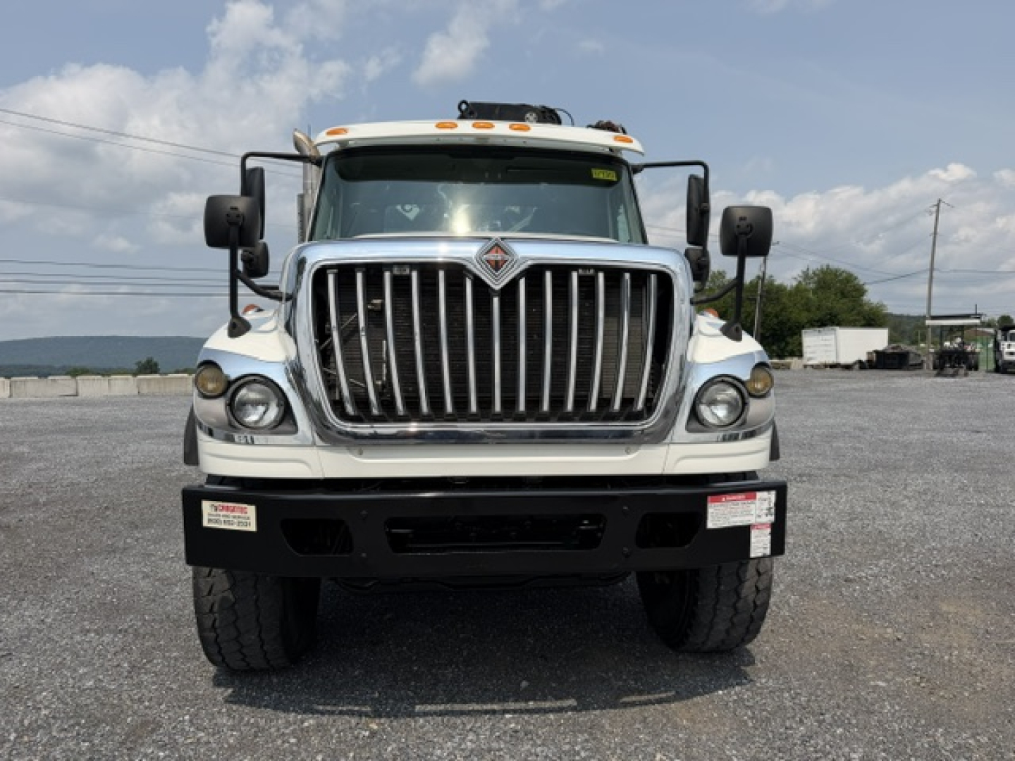 Front view of a 2022 International 7600 SBA Work Star truck showing a large chrome grille, dual large headlights, and heavy-duty bumper.