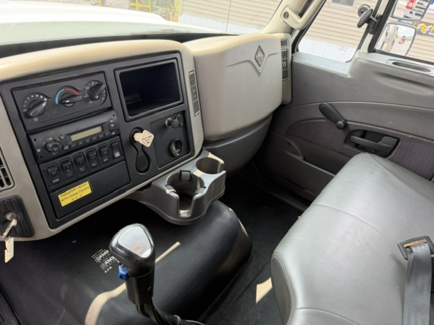 Cab interior of a 2022 International 7600 SBA Work Star truck showing dashboard controls and steering area.