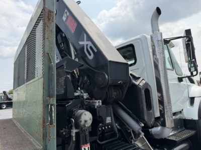 International 7600 SBA Work Star truck with crane attachment in side view showing hydraulic joints, black crane arm, and metal mesh cage.