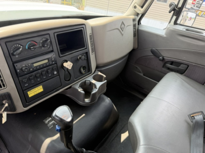 Cab interior of a 2022 International 7600 SBA Work Star truck showing dashboard controls and steering area.