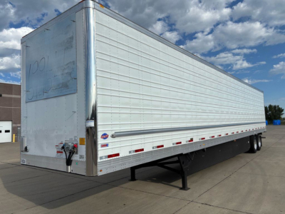 Trailer side view of a new 2027 utility refrigerated trailer, silver exterior, with a raised landing gear and rear door hinge area visible.