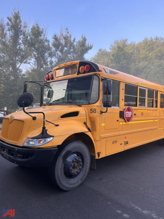 School bus in-service showing front left side with stop sign extended and route number 58.