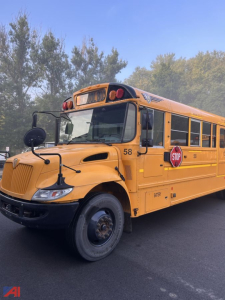 School bus in-service showing front left side with stop sign extended and route number 58.