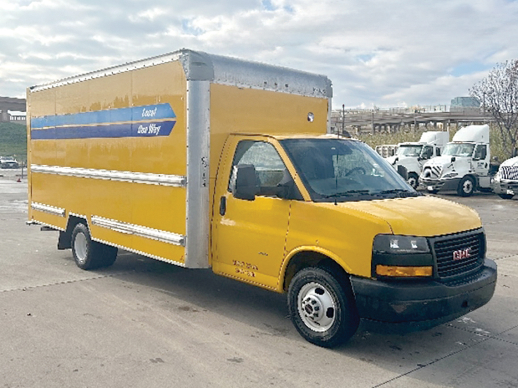 GMC Savana box truck in yellow with cargo box and blue stripe on side, front view showing cab and cargo area