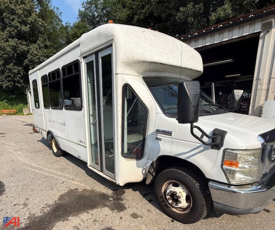 Ford E-350 shuttle bus with wheelchair lift showing side entry and front passenger door.