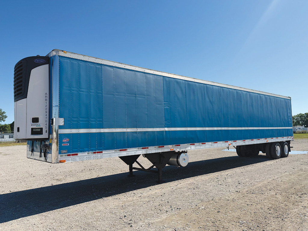 Trailer side view showing a blue 2012 Utility 3000R refrigerated trailer with white lower side rails and white refrigeration unit at front left.