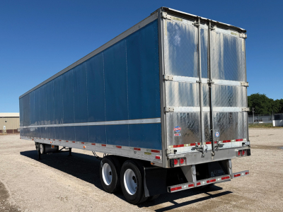 Trailer showing rear and side view of a blue Utility 3000R reefer trailer with aluminum doors, dual rear doors, and tandem axles.