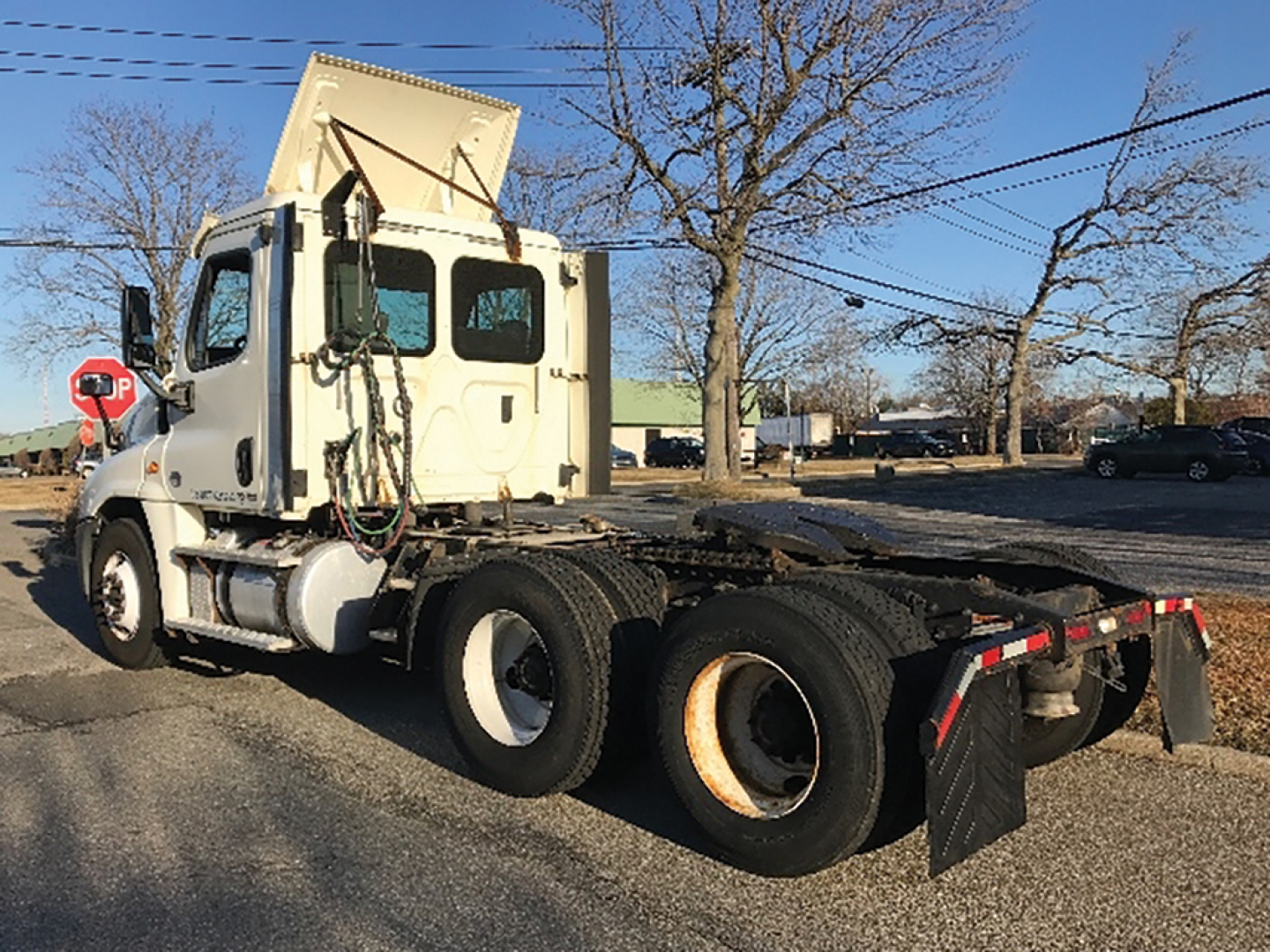 Truck cab and chassis of a 2018 Freightliner Cascadia125 daycab tractor, front left side view, VIN 3AKJGEDV8JSJH2014 visible on listing context, with dual rear axles and fifth wheel area.