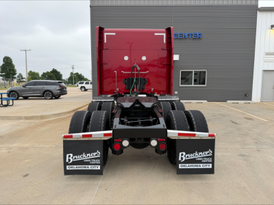 Peterbilt 579 rear view showing fifth wheel and dual rear axles with mud flaps and branding on mud flaps