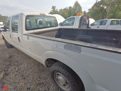 Ford F-250 Super Duty crew cab pickup truck in a used condition with a long truck bed.