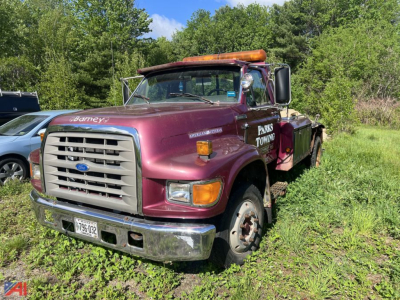 Ford F-800 tow truck in maroon showing front grille and bumper