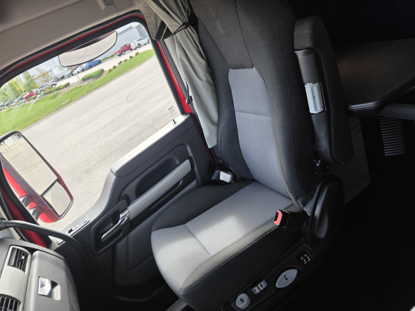 Truck interior seat and door area of a Kenworth T680 cab; visible text includes no explicit labels in image, but the surrounding listing shows VIN, stock number, category, type, and condition.