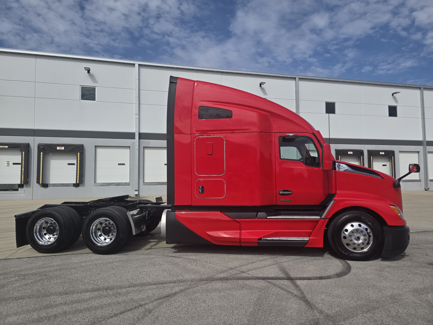 Kenworth T680 sleeper cab tractor in red side profile, 6-wheel tandem rear, adapter plates visible; no readable labels or sticker text in image.
