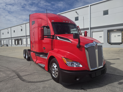Kenworth T680 tractor in red color shown from front-left view with large chrome grille and sleeper cab.