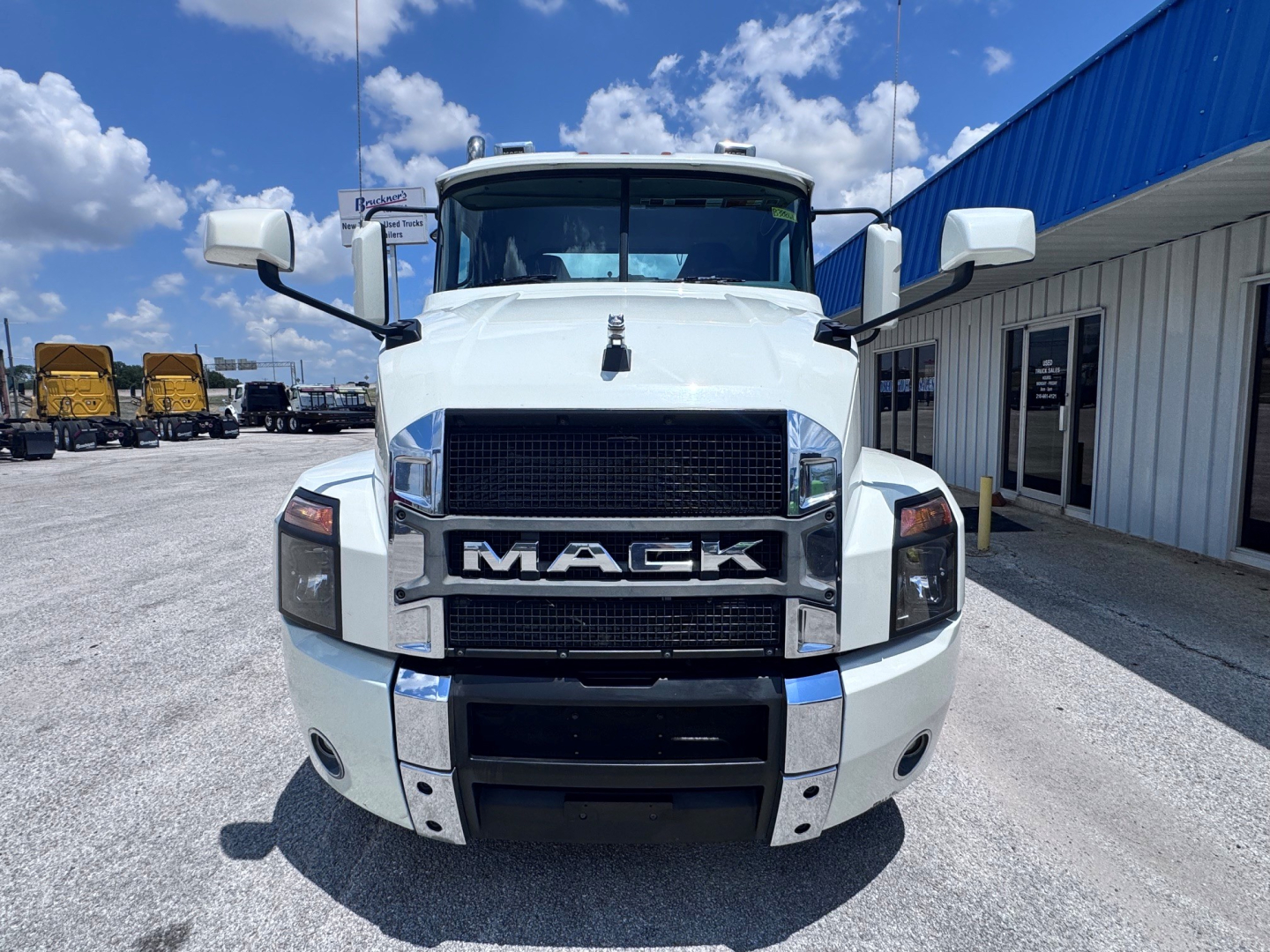 Front view of a white 2020 Mack Anthem conventional daycab truck showing large grille with MACK emblem, chrome bumper accents, and side mirrors.