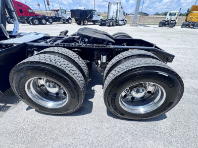 Mack Anthem 6x4 tractor chassis with dual rear axles and wheels visible in a truck yard