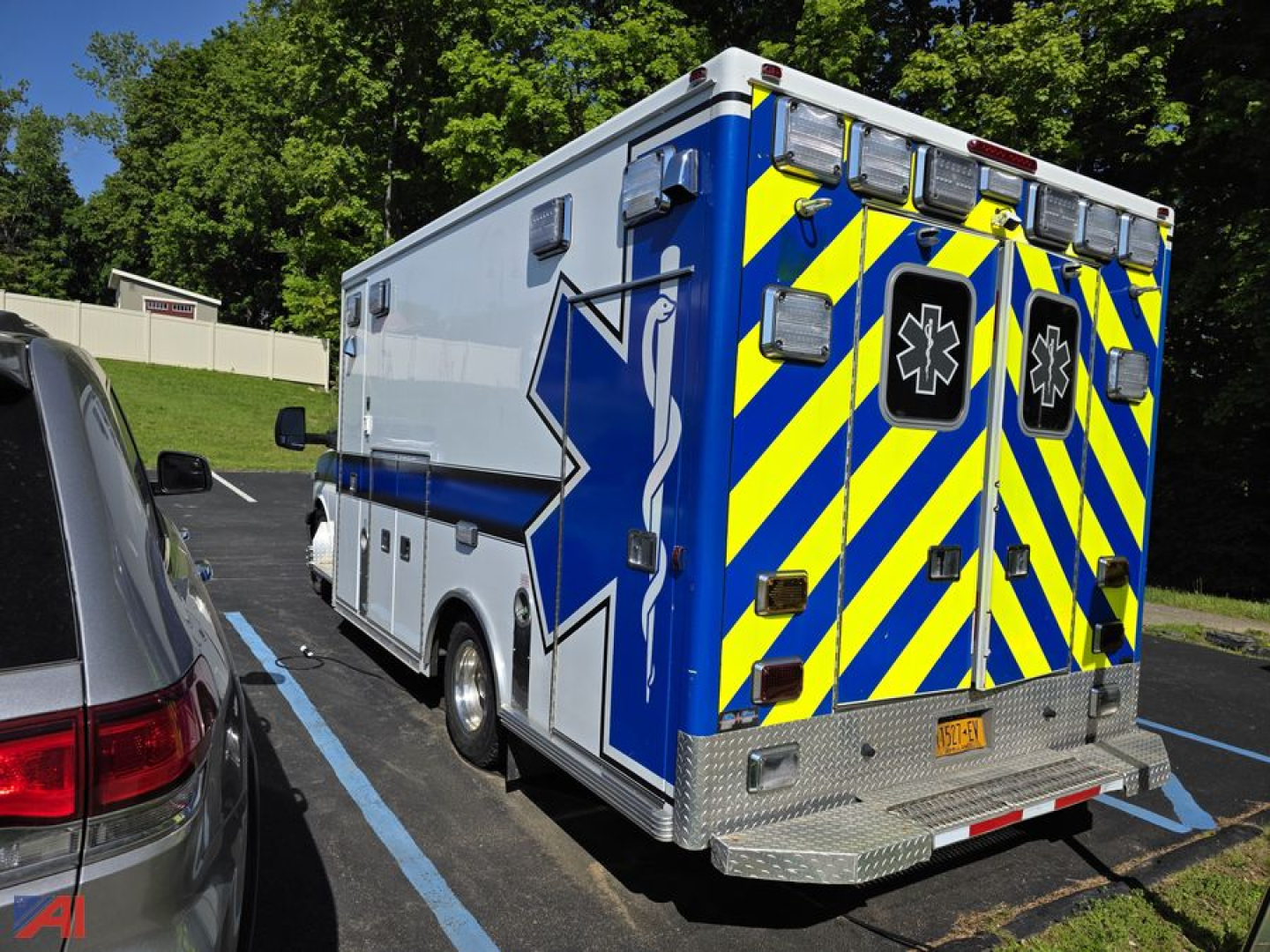 Ambulance rear and side view of a 2014 GMC Savana ambulance in a parking lot.