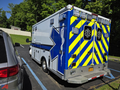 Ambulance rear and side view of a 2014 GMC Savana ambulance in a parking lot.