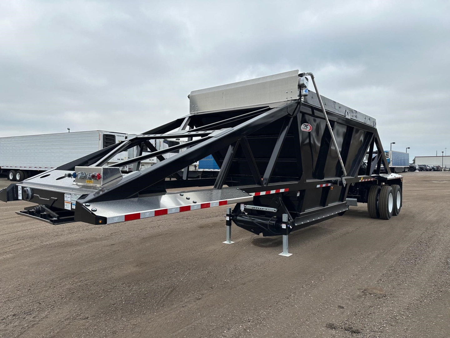 Trailer: 2027 CPS light weight bottom dump in-service showing side rails and hydraulic structure.