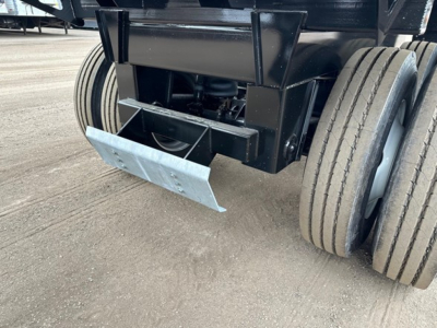 Trailer rear showing bottom dump mechanism and dual rear axles with heavy-duty wheels.