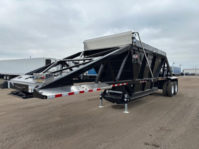 Bottom dump trailer with lightweight, open-frame steel structure and hydraulic dump mechanism, dual axle, ramped tail section, and front storage box.
