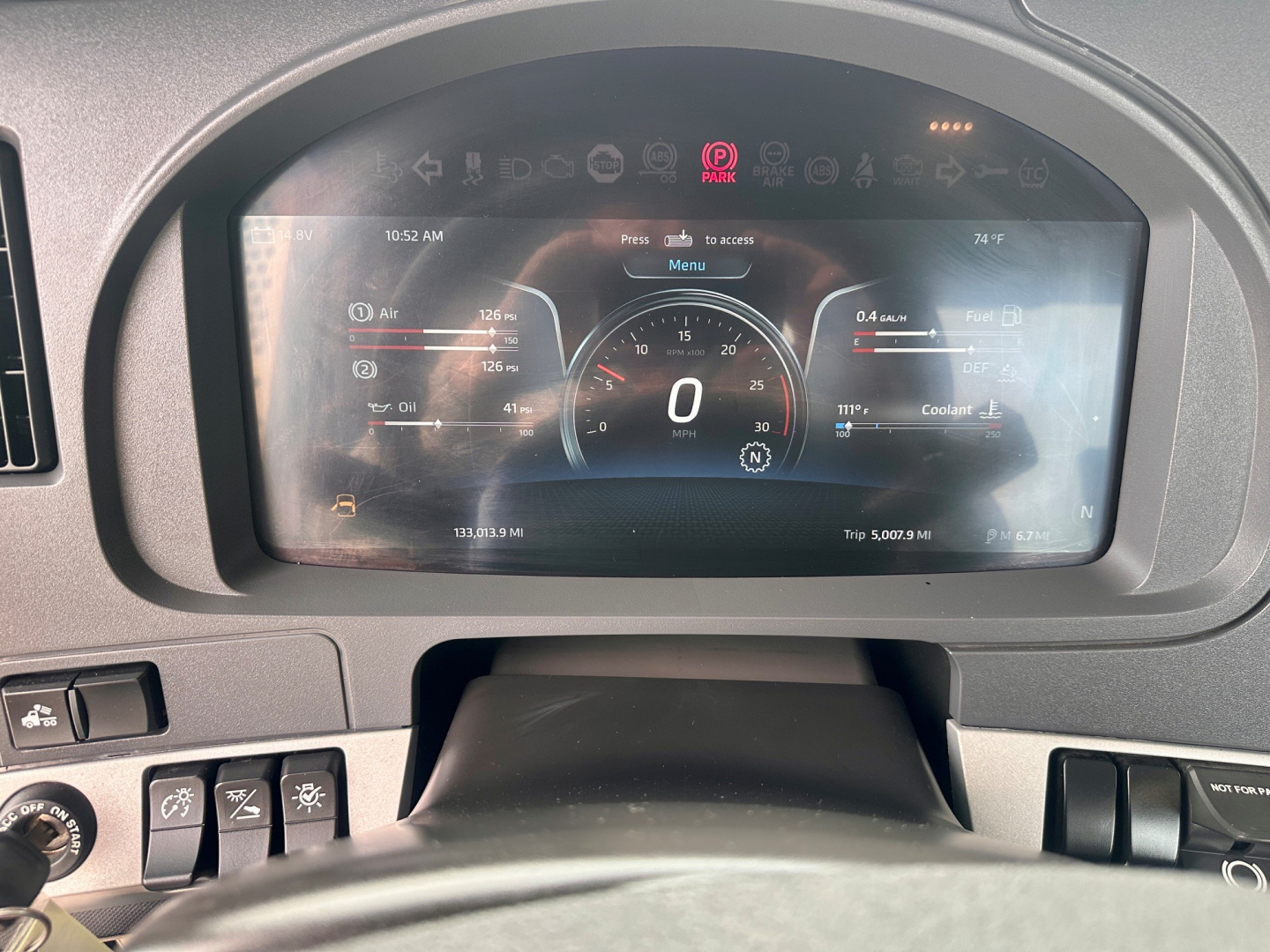 Kenworth truck interior dash display showing digital speedometer and vehicle status gauges.