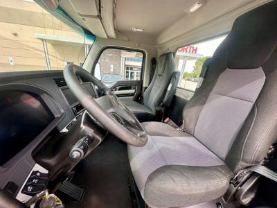 Kenworth T880 truck interior showing steering wheel, driver and passenger seats, dashboard, and windows; view from driver seat.