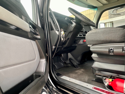 Kenworth T880 interior view showing driver seat and dashboard with steering wheel and pedals.
