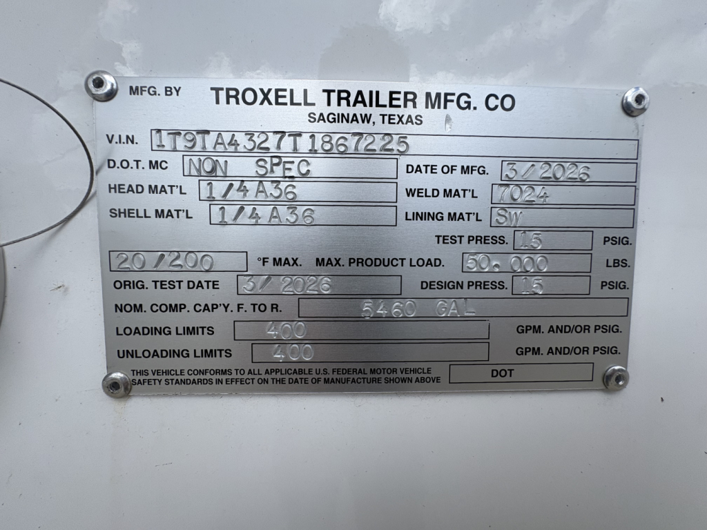 Data plate on Troxell trailer showing manufacturer, VIN, and specifications: MFG BY TROXELL TRAILER MFG. CO SAGINAW, TEXAS; V.I.N. 1T9TA4327T1867225; D.O.T. MC NON SPEC; DATE OF MFG 3/2026; HEAD MATL 1 1/4 A36; WELD MATL 1/0?; SHELL MATL 1/