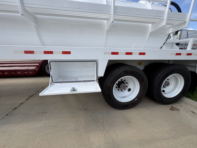 Troxell 130BBL vacuum trailer showing white body with dual rear wheels and side access step extended.