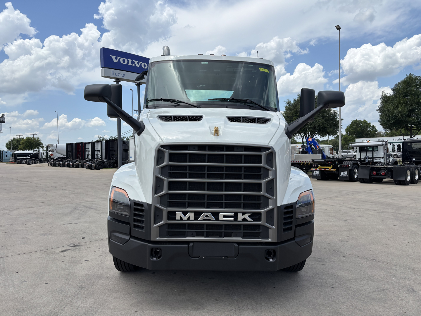 Mack AN64 dump truck front view showing bold grille with MACK branding and large side mirrors.