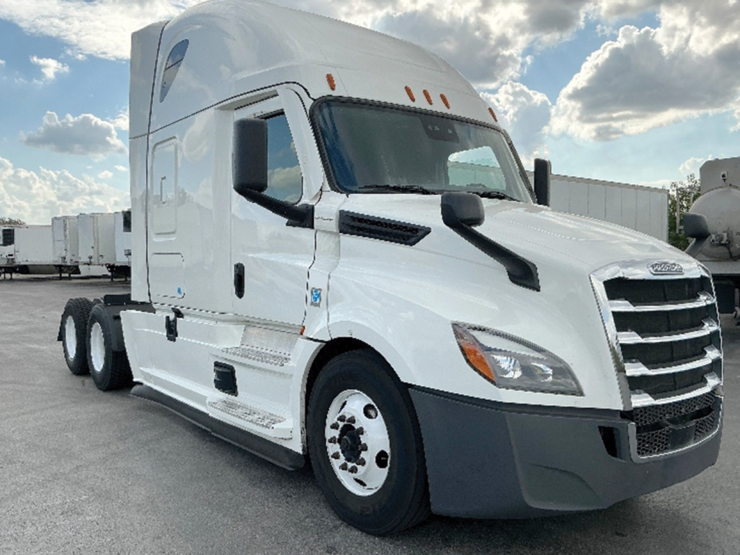 Freightliner Cascadia126 sleeper tractor viewed from front-left showing cab and grille with headlights and side mirror.