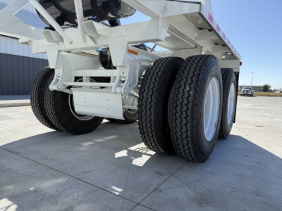 Armor Lite SBD40 Spring trailer undercarriage showing dual rear axles and tires with white chassis.
