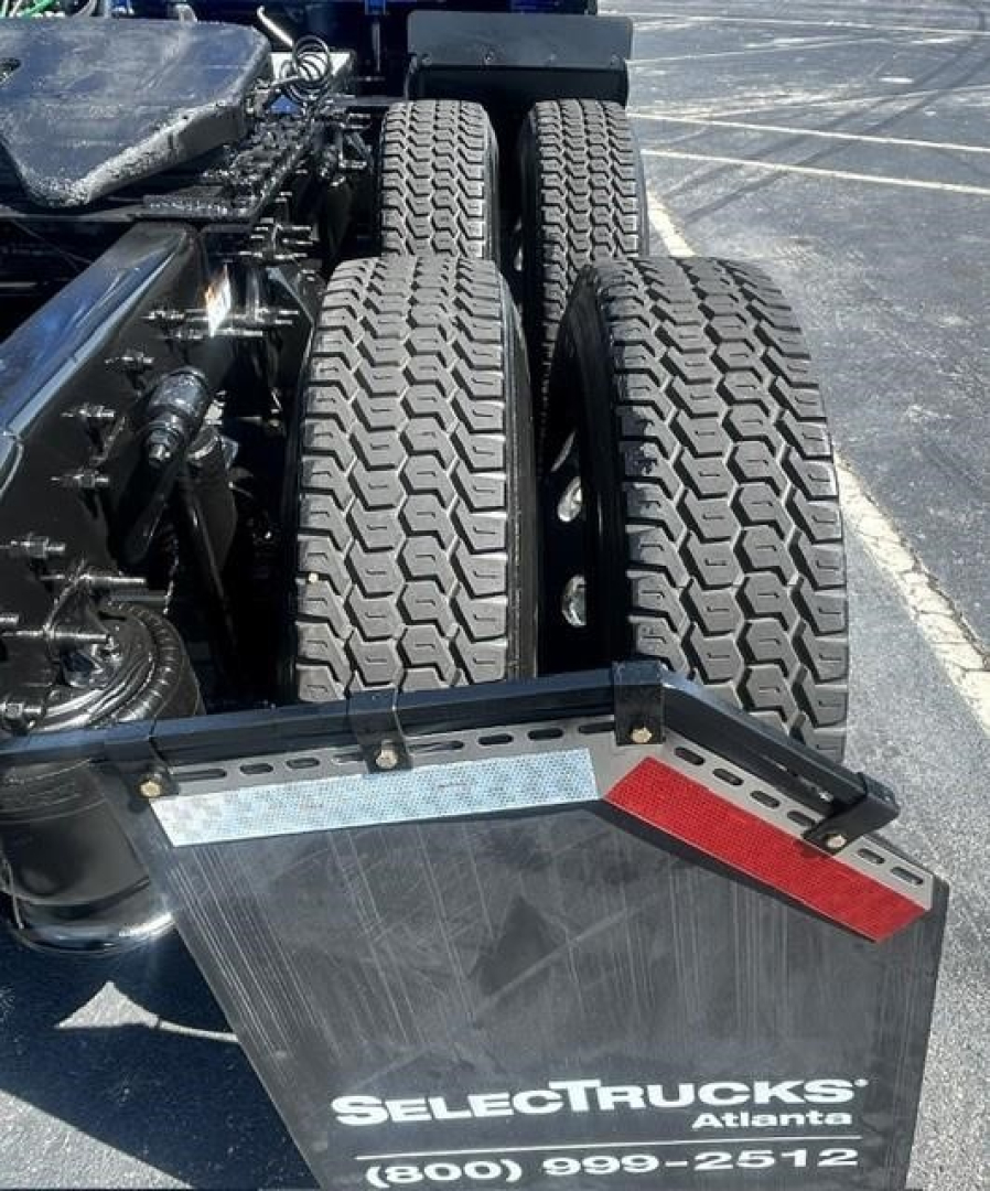 Freightliner Cascadia 126 rear chassis with dual rear axles and mudflap showing SelectTrucks Atlanta branding, heavy-duty tires in view