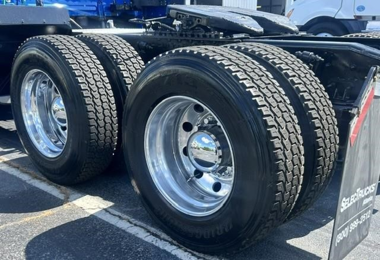 Freightliner Cascadia rear dual rear axles showing polished aluminum wheels and heavy-duty tires.