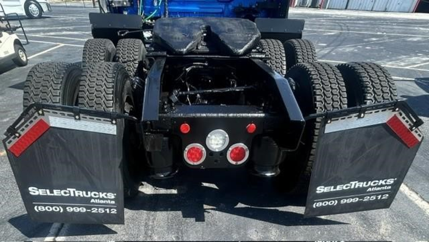 Rear view of a 2022 Freightliner Cascadia 126 tractor showing fifth wheel area, dual rear axles, and mud flaps with SelectTrucks branding.