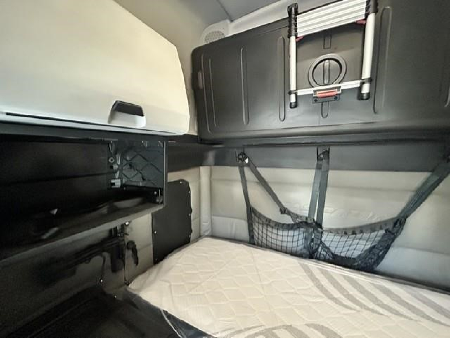Freightliner Cascadia 126 sleeper cab interior showing bunk area and storage nets
