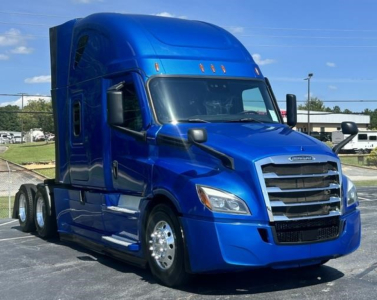 Freightliner Cascadia 126 conventional sleeper truck in blue, front three-quarter view.