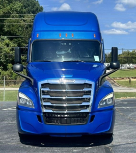 Freightliner Cascadia 126 truck front view in blue with large grille and headlights.